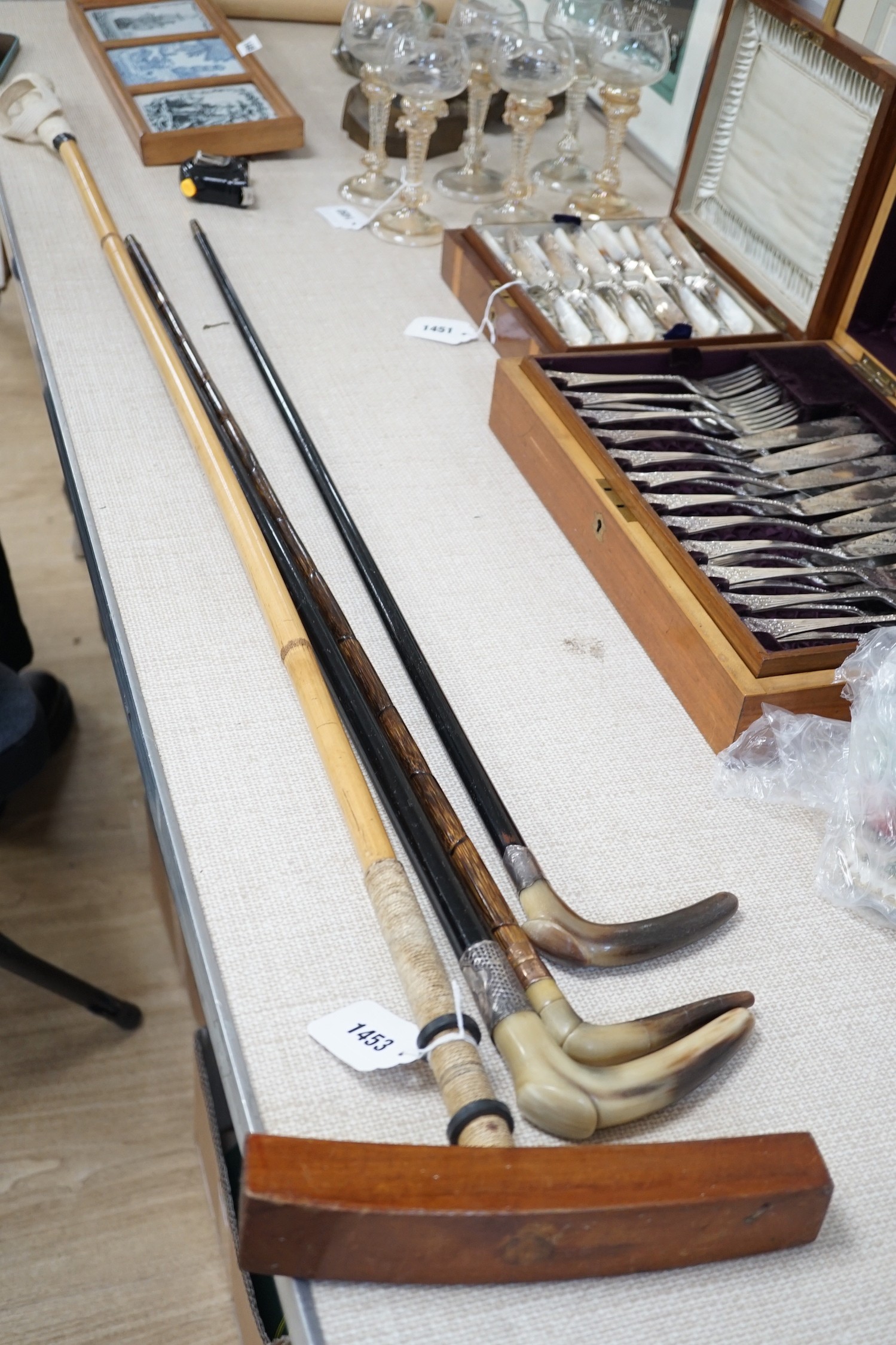 Three horn handled walking sticks and a polo mallet, Longest 138cm